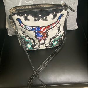 Purse, western with bull skull . I don’t know the brand but it’s so cute.